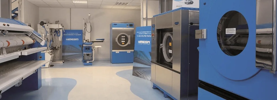 Commercial laundry with industrial washer-extractors and a flatwork ironer