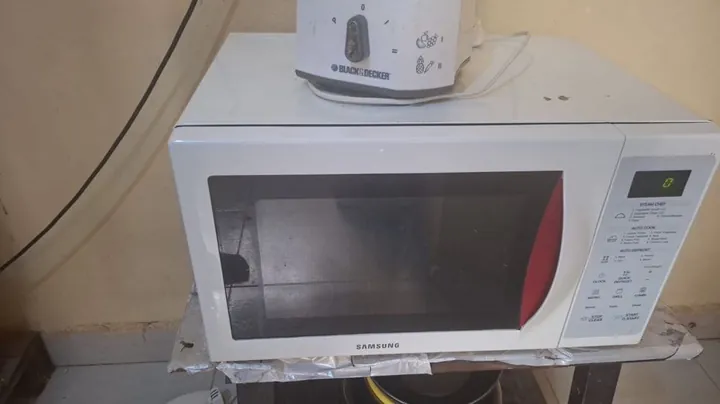 White Samsung microwave on a repair visit
